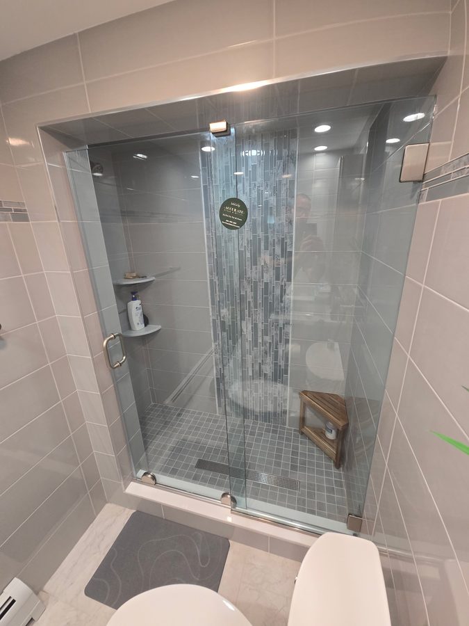 Frameless corner shower enclosure
