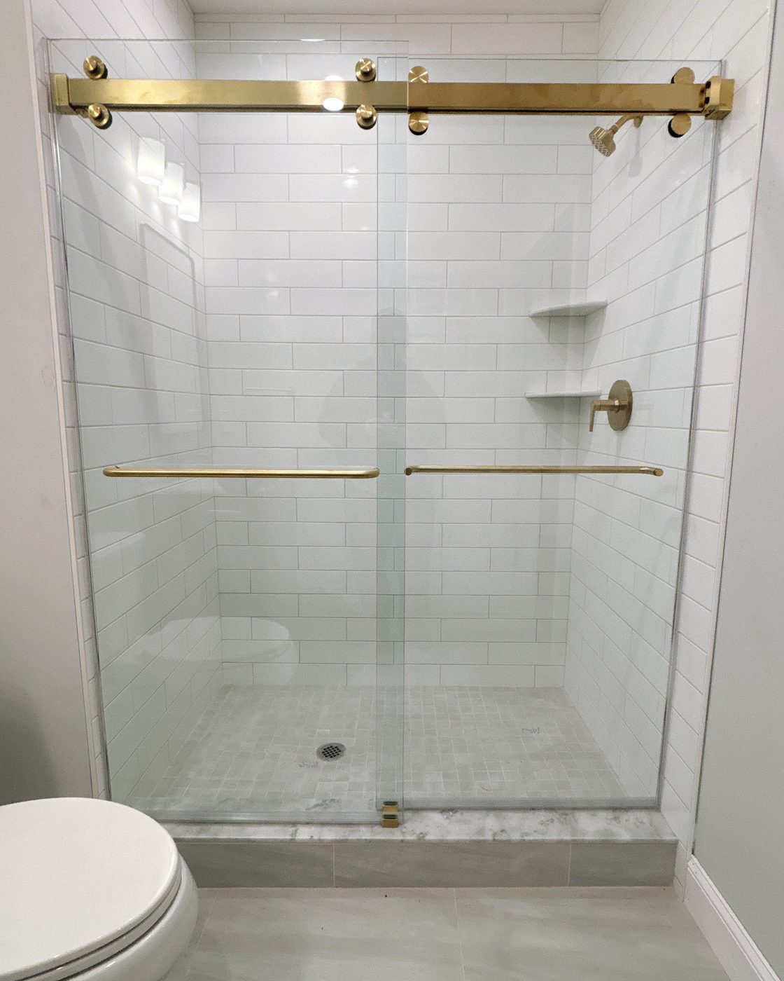 Frameless bypass shower doors with gold rollers