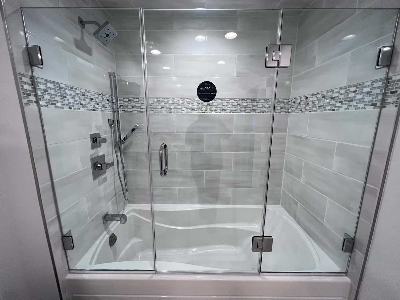 Frameless sliding shower with a tile accent band