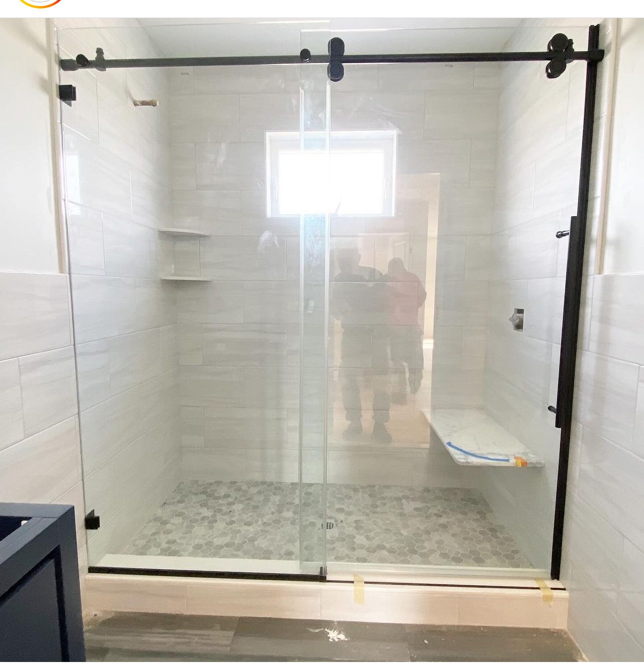 Frameless glass shower with black barn-door hardware