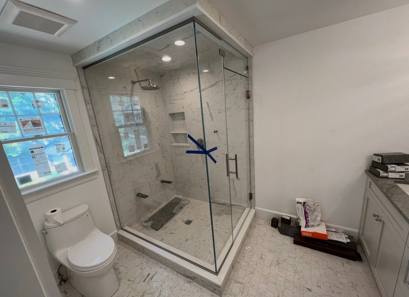 Corner frameless glass shower with a black frame